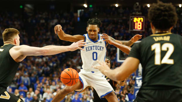 Kentucky's guard Rob Dillingham (0) gets fouled against Vanderbilt during the first half of an NCAA basketball game at Rupp Arena in Lexington, Ky., Wednesday, Mar. 6, 2024